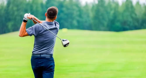 Golfer at the end of his swing on the golf course